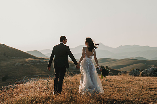 Wedding couple walking in field